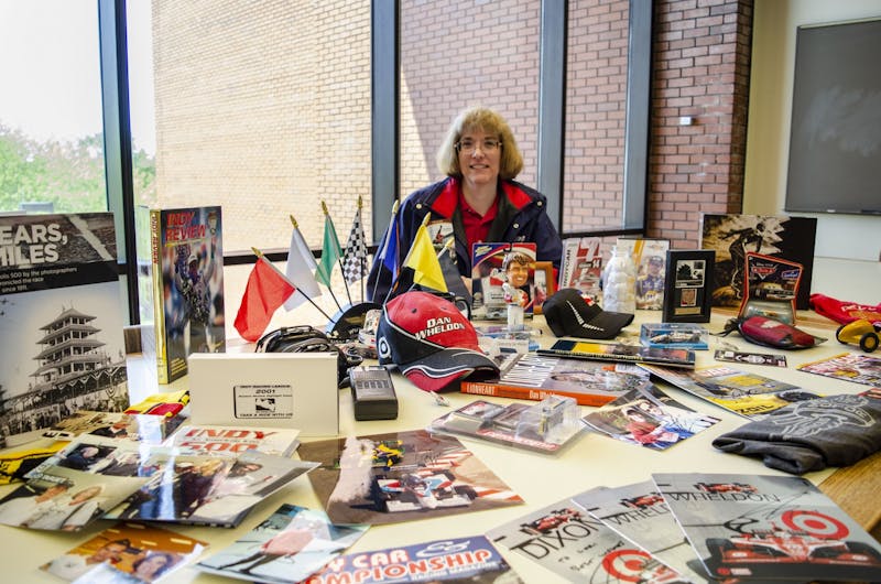 Lori Siefker sits behind a portion of her IndyCar memorabilia collection May 14, 2019, in Bracken Library. The collection pictured is a small fraction of everything she has amassed over the years. Stephanie Amador, DN