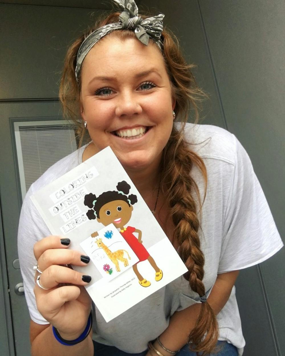 <p>Graduate student Kelly Hopkins illustrates children's books as a side job. Hopkins teamed up with her former&nbsp;high school vice principal,&nbsp;Jacquelyn Thomas-Miller, to write and illustrate their first picture book,&nbsp;“Coloring Outside the Lines.” <em>Kelly Hopkins // Photo Provided</em></p>