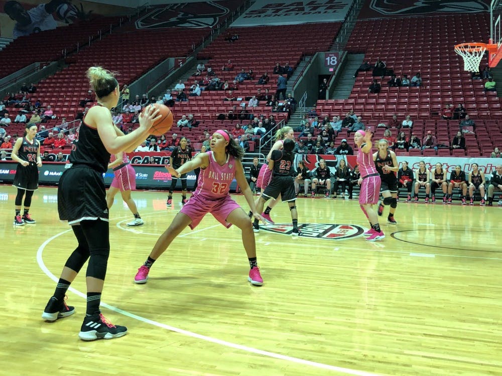 <p>Ball State sophomore forward Oshlynn Brown defends a Northern Illinois player Saturday, Feb. 9, in John E. Worthen Arena. The Cardinals fell to the Huskies, 93-83. <strong>Gabi Glass, DN</strong></p>