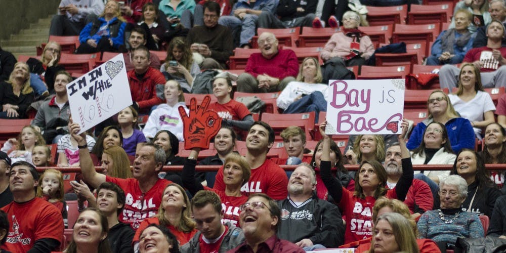 Fans hold up signs during the meet against Townson on Jan. 17 at Worthen Arena. DN PHOTO BREANNA DAUGHERTY