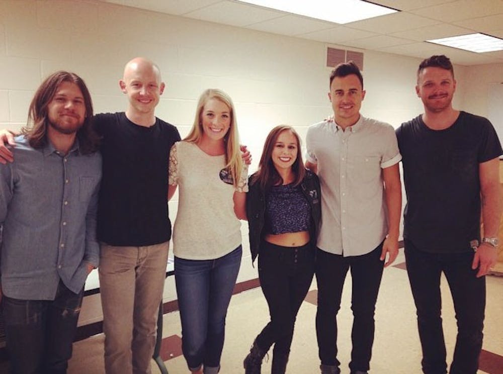 <p>Seniors Madeline Mileski (center left) and Cece Ytell (center right) pose with members of The Fray during a meet-and-greet before the show on Weddnesday. </p>