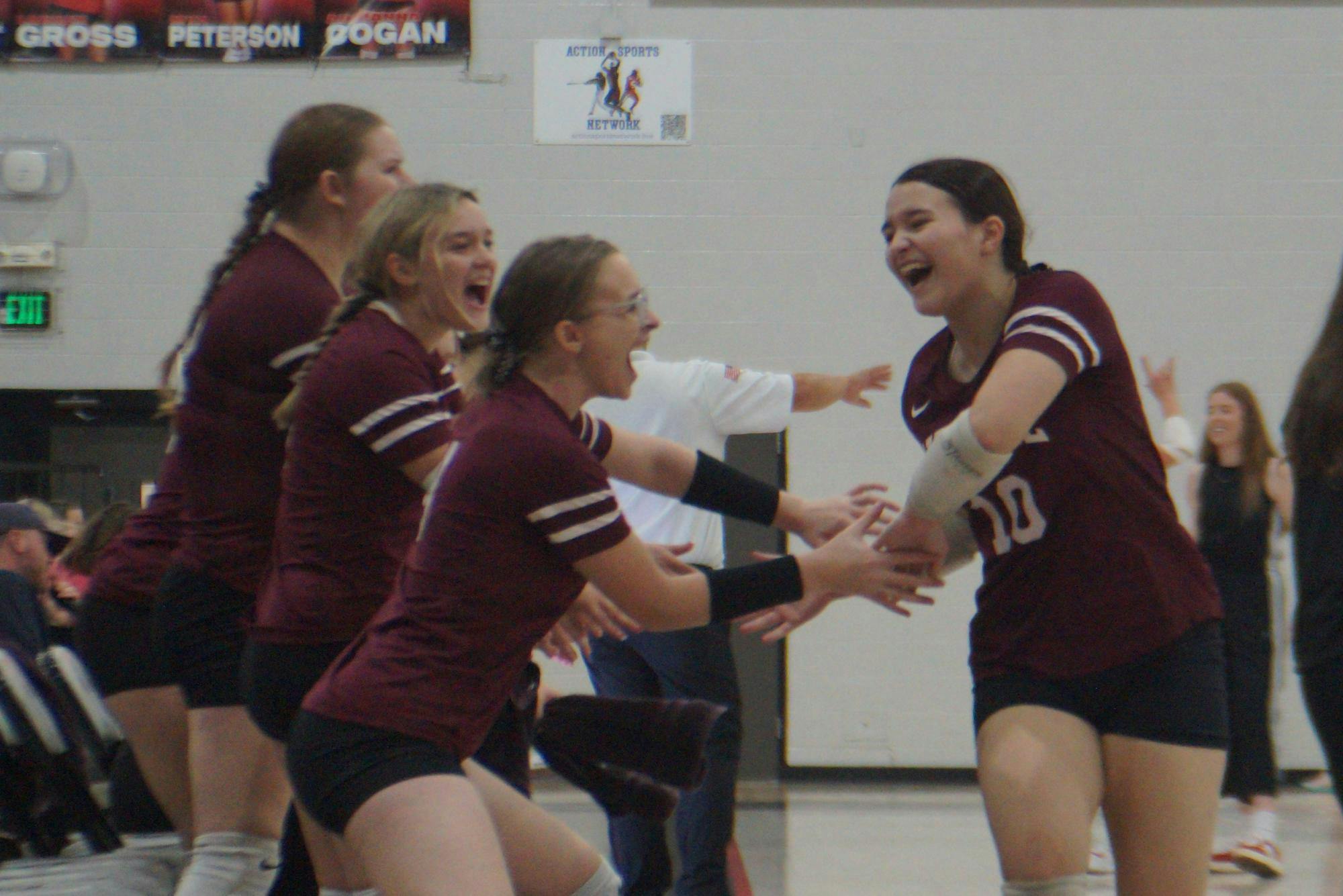Sophomore Jenna Dent, 10, high-fives her team after she subs out in an intense match against Eastbrook. The Wes-Del Warriors placed fourth out of five in the Eastbrook Invitational. PHOTO BY NICK ROARK
