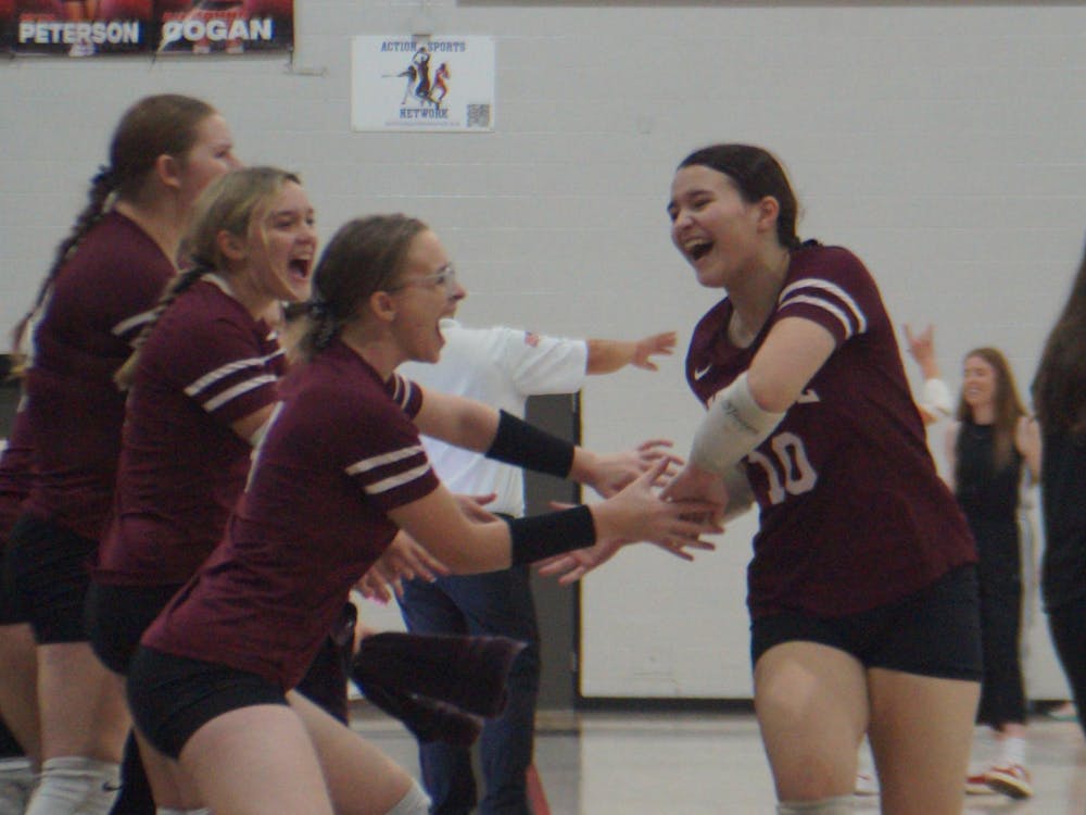 Sophomore Jenna Dent, 10, high-fives her team after she subs out in an intense match against Eastbrook. The Wes-Del Warriors placed fourth out of five in the Eastbrook Invitational. PHOTO BY NICK ROARK
