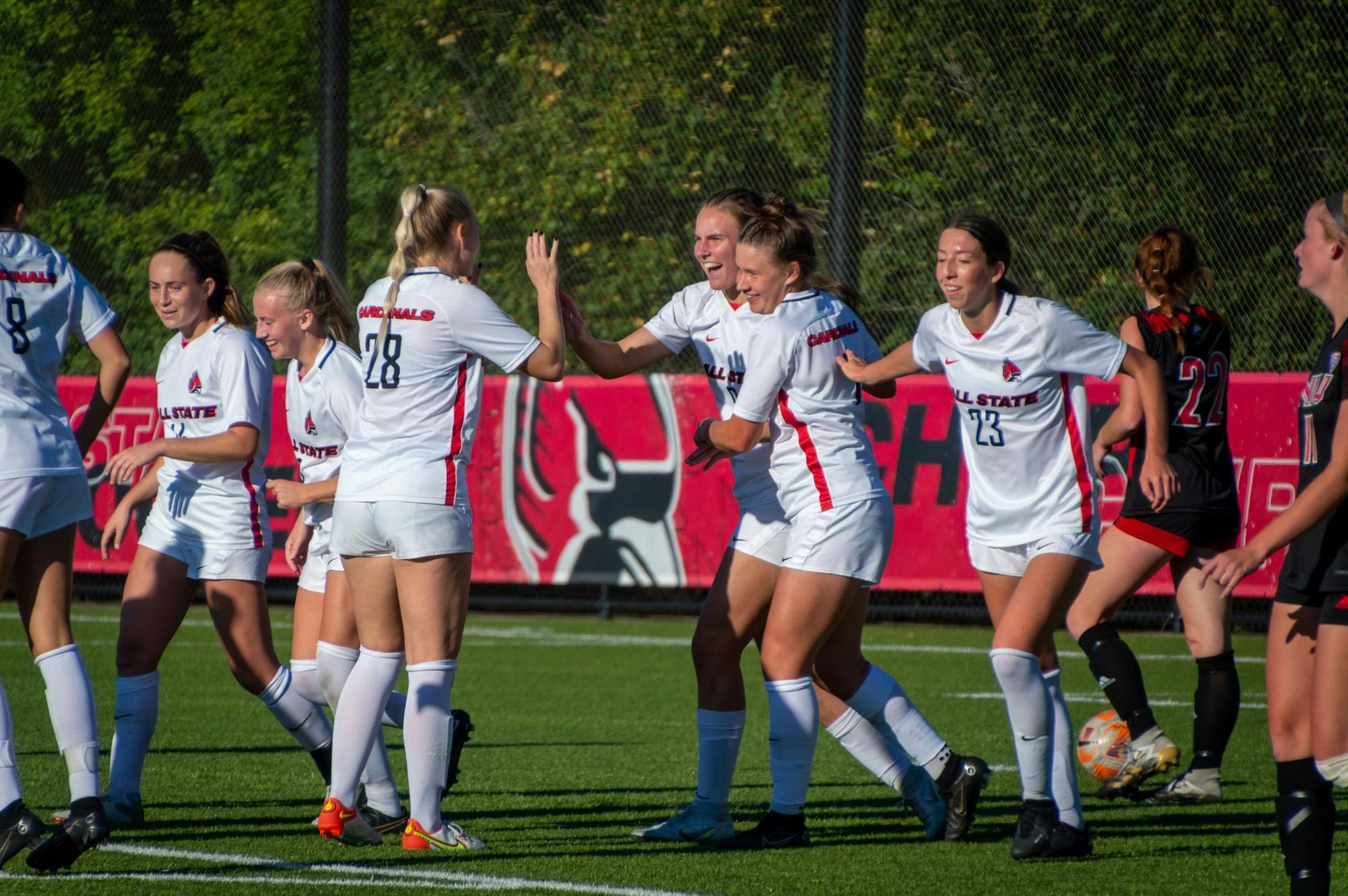 The Cardinals celebrate after Emily Roper scores the final point of the game against Northern Illinois Sept. 29. Ball State defeated the Huskies 4-1. Meghan Sawitzke, DN.