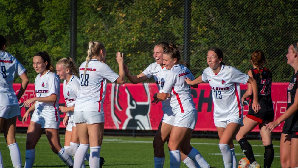The Cardinals celebrate after Emily Roper scores the final point of the game against Northern Illinois Sept. 29. Ball State defeated the Huskies 4-1. Meghan Sawitzke, DN.