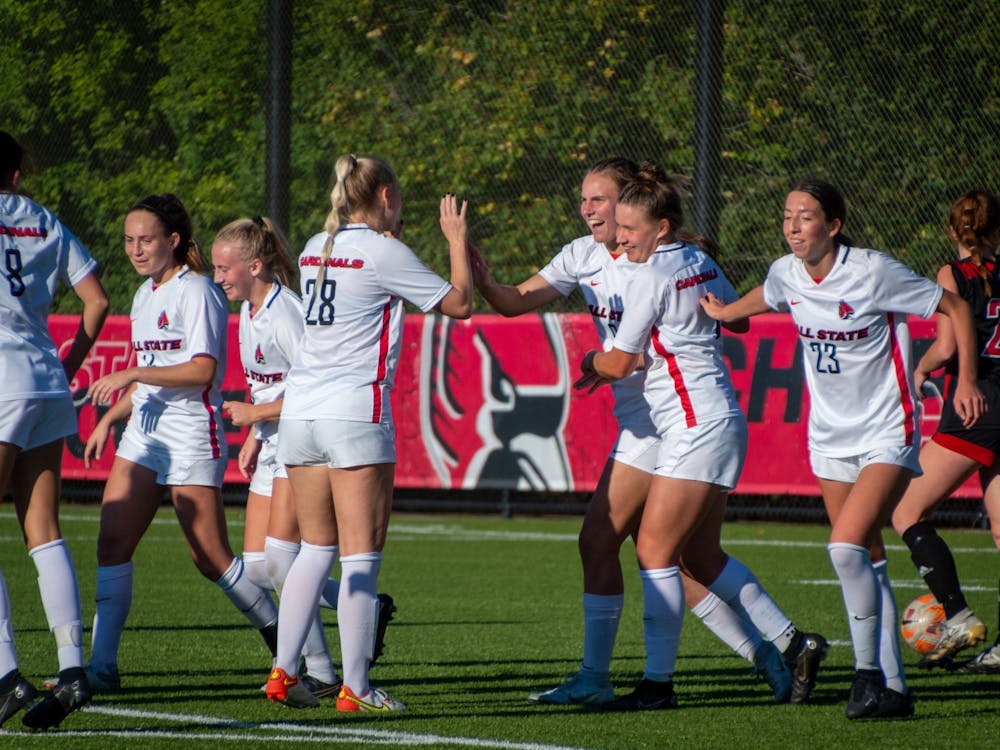 The Cardinals celebrate after Emily Roper scores the final point of the game against Northern Illinois Sept. 29. Ball State defeated the Huskies 4-1. Meghan Sawitzke, DN.
