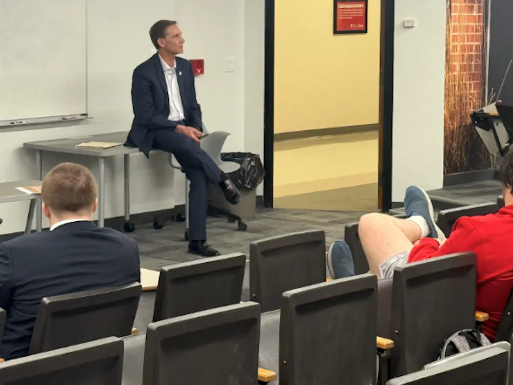 Muncie Mayor Dan Ridenour speaks with Ball State University students during a campus visit, discussing projects and future community development