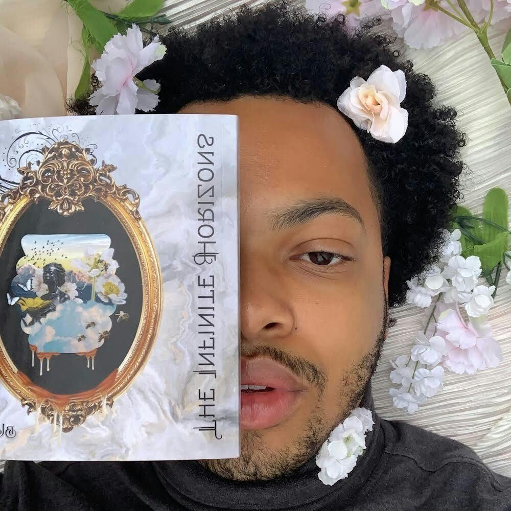 Braxton Williams, 2020 Ball State sociology graduate and poet, holds a paperback copy of his self-published poetry book, "The Infinite Horizons," after the book released on Amazon Sept. 18, 2020. In support of his work, Williams' mother organized and broadcasted a book launch party on Zoom that November.

