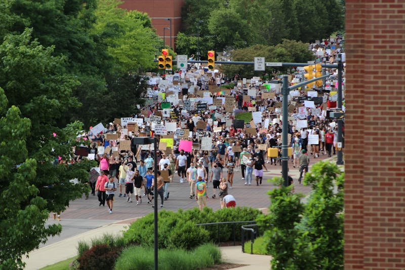 Protesters march through the Scramble Light June 4, 2020, at the intersection of Riverside and McKinley Avenues. Ball State students, faculty, staff and University Police Department officers as well as community members marched in response to the death of George Floyd. Bailey Cline, DN