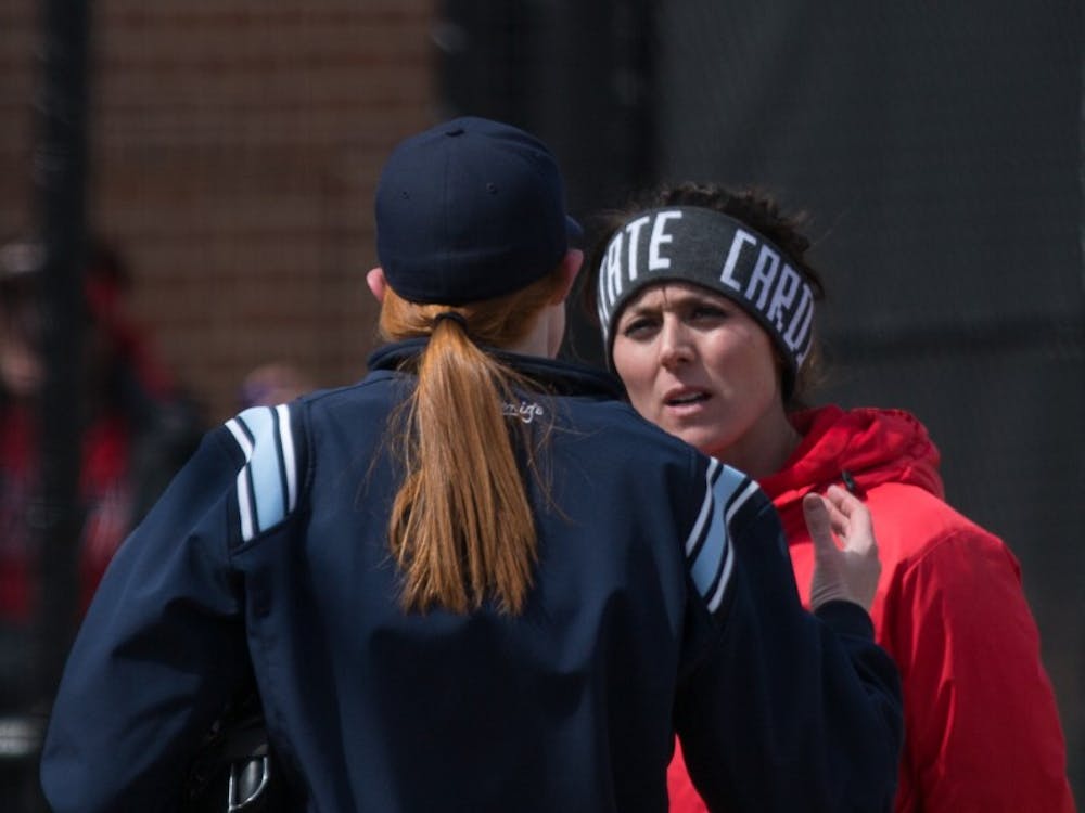 Head Coach Megan Ciolli Bartlett talks with an umpire after a call in the fifth inning during the Cardinals' game against Kent State April 7 at the Softball Field at First Merchants Ballpark Complex. Eric Pritchett, DN