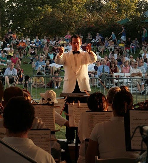 Conductor Douglas Droste directs the Muncie Symphony Orchestra in their final performance of the season at Minnetrista. The final concert called “Picnic & Pops” is a large draw for the community. DN PHOTO LOGAN WINSLOW