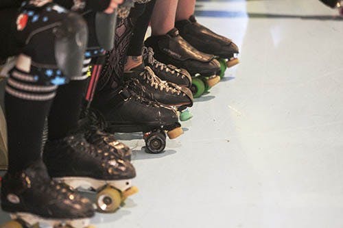 Skaters of the South Bend Bonnie Dooms wait on the bench at Gibson’s Skating Rink on Saturday evening. The Bonnie Dooms took on Muncie’s local team, the Cornfed Derby Dames. DN PHOTO JORDAN HUFFER