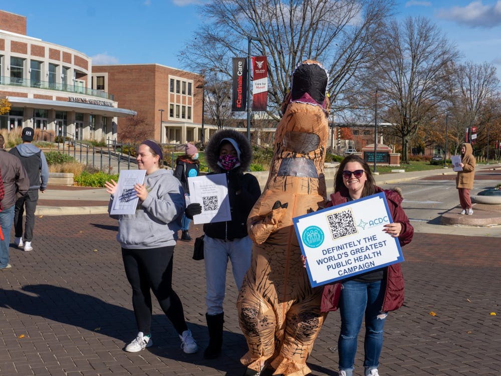 Students encourage pedestrians to check out the drug takeback event Nov. 18 at the Scramble Light. Organizers provided links to drug addiction resources via QR codes at the event. John Lynch, DN