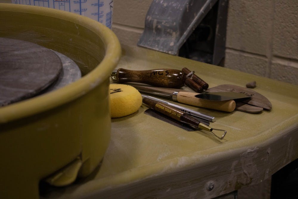 Tools students use to shape clay sit on the back of the pottery wheel Wednesday, Aug. 22, 2018 in the Arts and Journalism Building room 225.  Two students in this semester's class have never handled clay before. Tier Morrow, DN