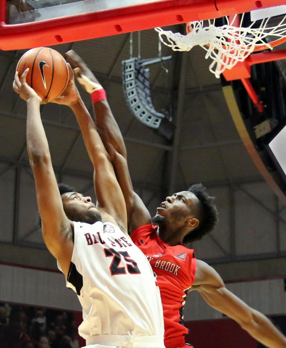 Sophomore forward Tahjai Teague gets fouled by Stony Brook’s Elijah Olaniyi during the Cardinals’ game against the Seawolves on Nov. 17 in John E. Worthen Arena. Teague was Ball State’s third leading scorer with 13 points. Paige Grider, DN