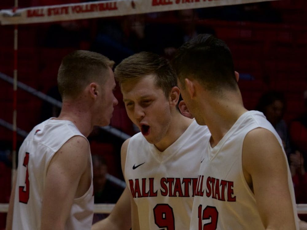 Junior Parker Swartz cheers after winning a volley against Quincy in the second game on March 31 at John E. Worthen Arena. The Ball State Cardinals won all three games played. Rebecca Slezak, DN
