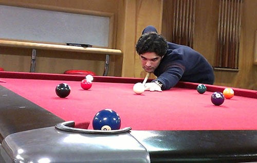 Nadeem Nooristani, a senior international student, practices pool after winning first place in a local tournament. He will now advance to the Association of College Unions International Collegiate 9-ball Championships this weekend. PHOTO PROVIDED BY BETH SWARY