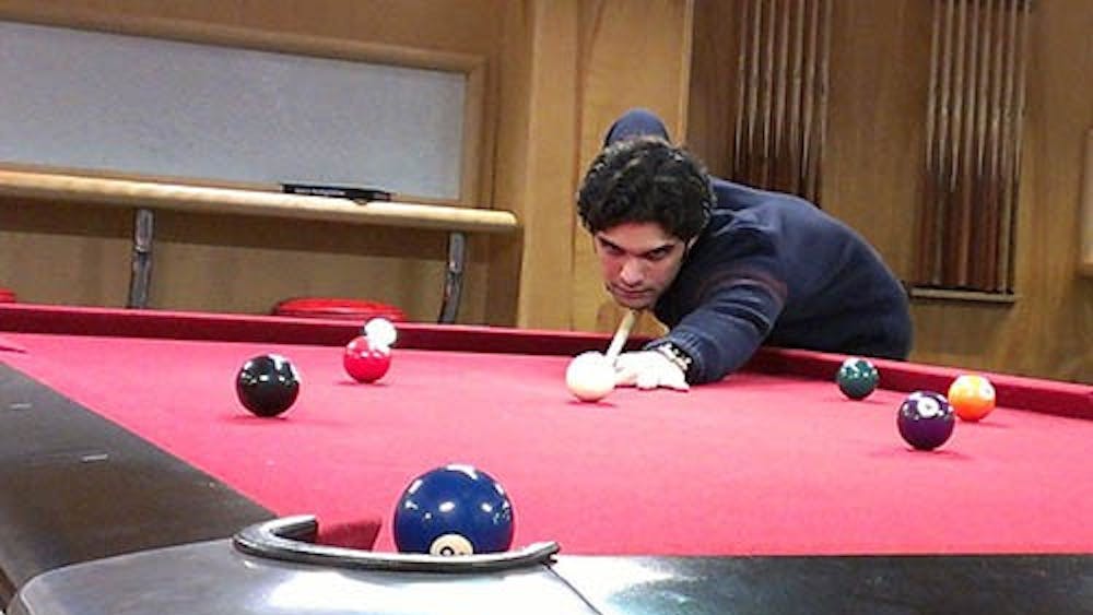Nadeem Nooristani, a senior international student, practices pool after winning first place in a local tournament. He will now advance to the Association of College Unions International Collegiate 9-ball Championships this weekend. PHOTO PROVIDED BY BETH SWARY