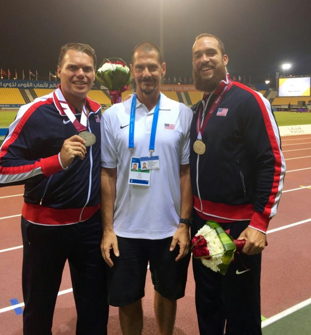 <h6>(From left to right) David Blair, Larry Judge and Jeremy Campbell pose for a picture following the 2015 IPC World Championships in Doha, Qatar. Judge coached the gold and silver medalists in the F44 discus throw. Larry Judge // Photo Provided</h6>