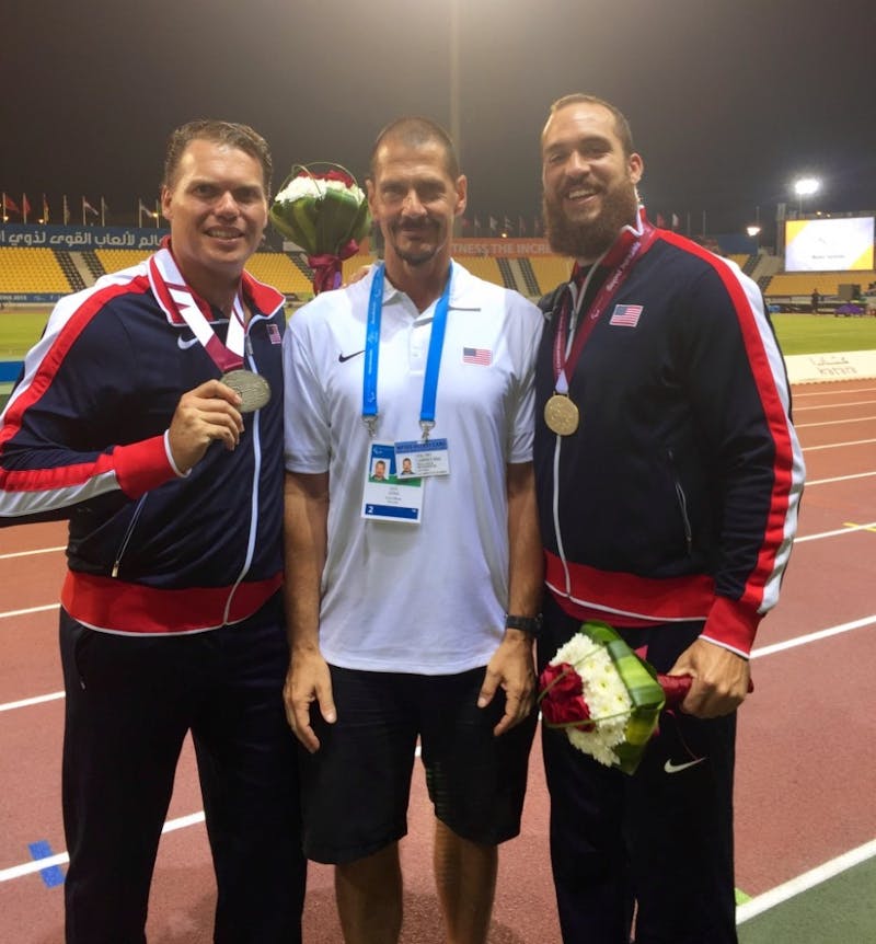 (From left to right) David Blair, Larry Judge and Jeremy Campbell pose for a picture following the 2015 IPC World Championships in Doha, Qatar. Judge coached the gold and silver medalists in the F44 discus throw. Larry Judge // Photo Provided