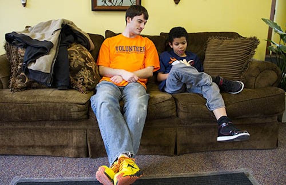 Motivate Our Minds volunteer James Simmons spends his time outside of being a student at Ball State to help nine-year-old Jeffrey Hawkins read “Harry Potter.” DN EMMA FLYNN