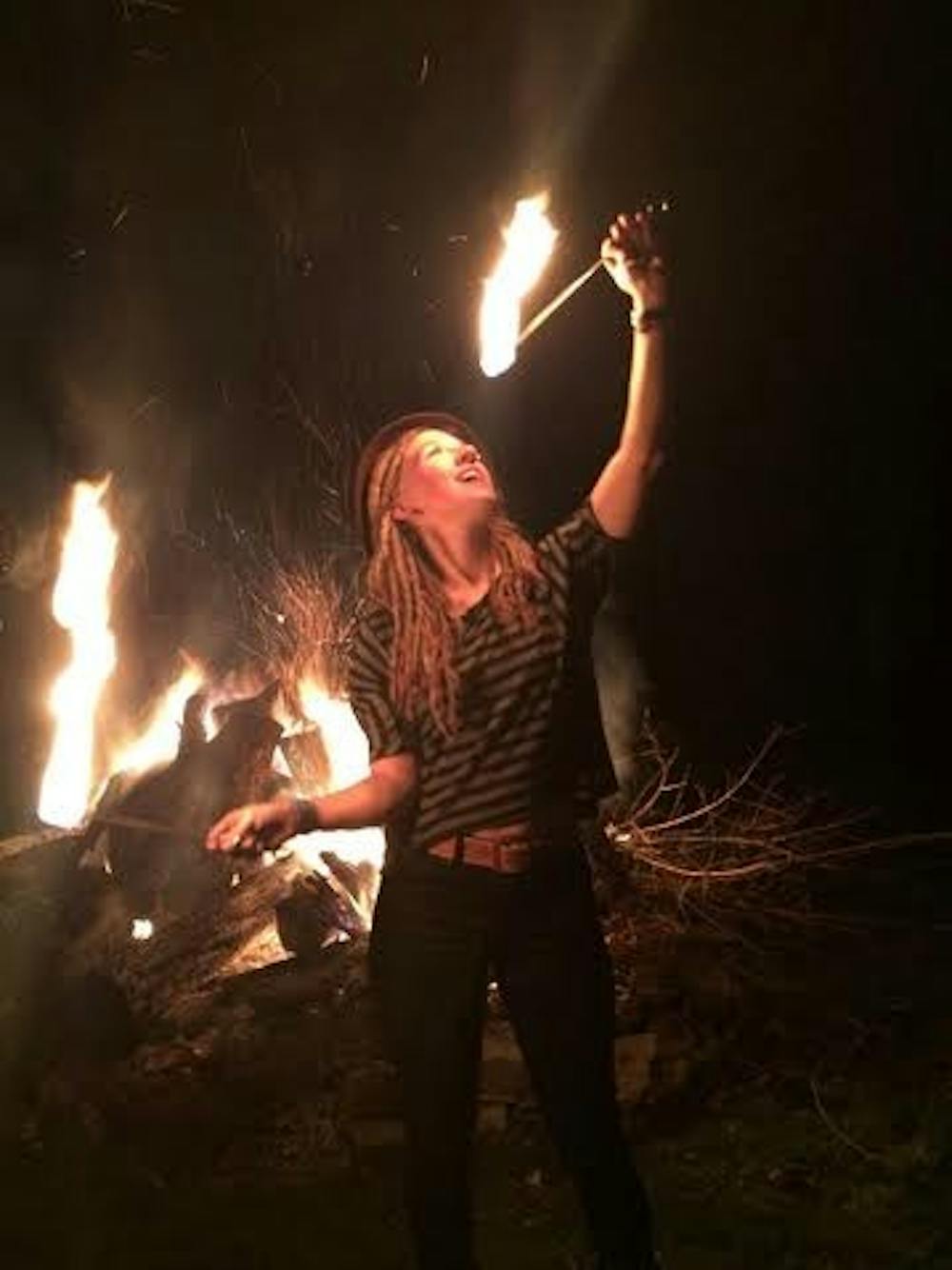 Alumna Kelzie Jo Selch prepares to "eat" fire. Selch and other flow artists perform on Mondays at Be Here Now. PHOTO PROVIDED BY KELZIE JO SELCH