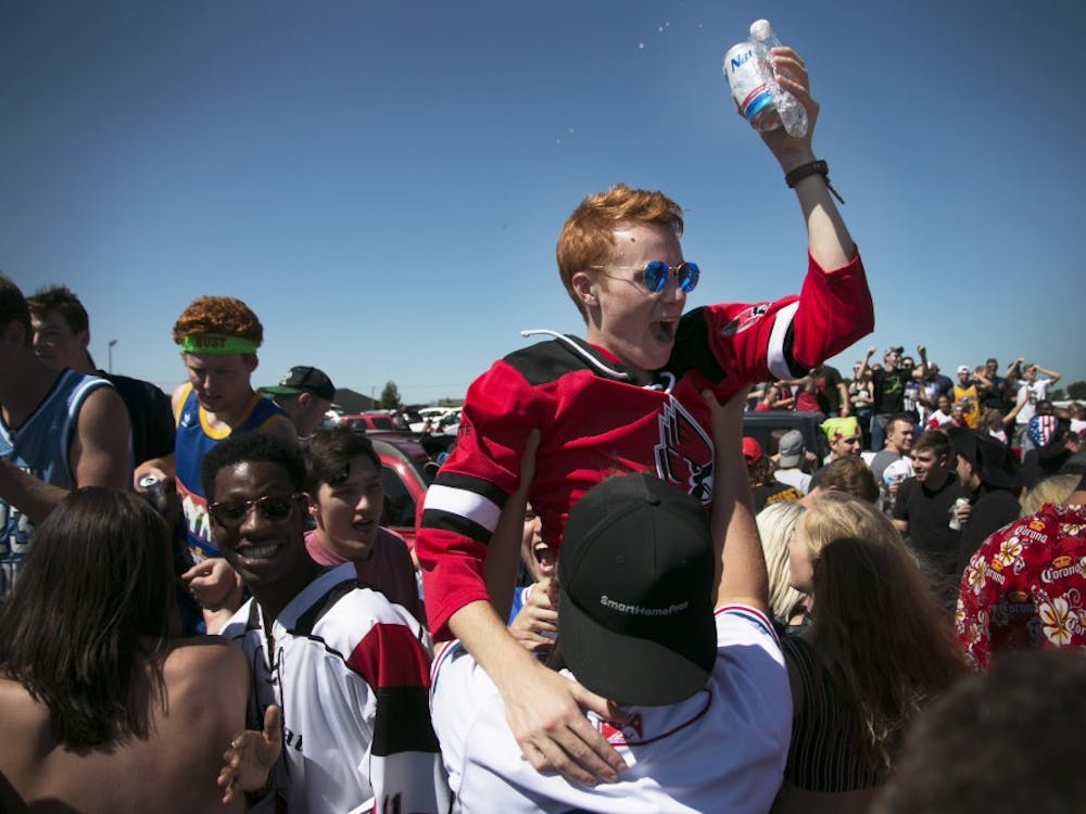 A Ball State student gets lifted up by a friend while attending a tailgate party before Ball State football faces off UAB at Scheumann Stadium on Sept. 9. Grace Hollars, DN