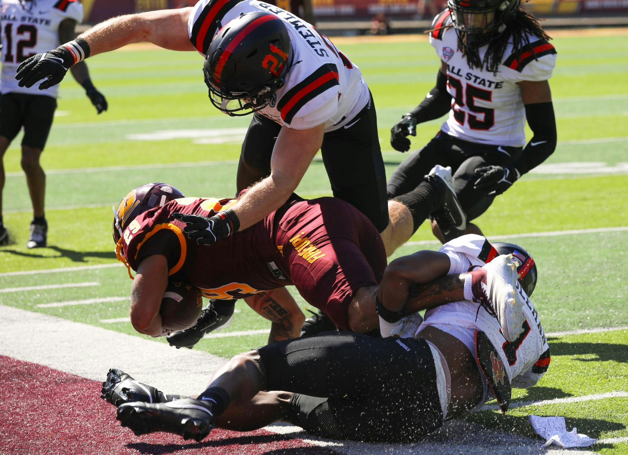 Ball State football players tackle opposing team Sept. 21 Kelly/Shorts Stadium. Ball State lost 34-37 against Central Michigan. Isabella Kemper, DN