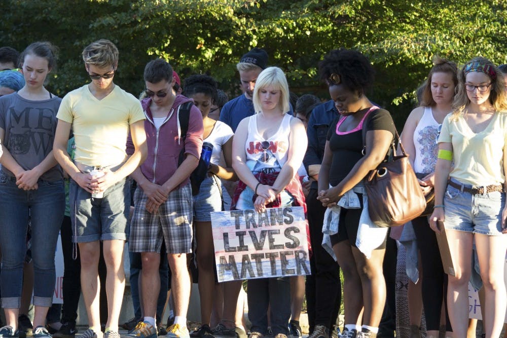 Ball State students participating in the Trans Lives Matter march on Sept. 17 stop in front of the Frog Baby for a moment of silence. DN PHOTO STEPHANIE AMADOR