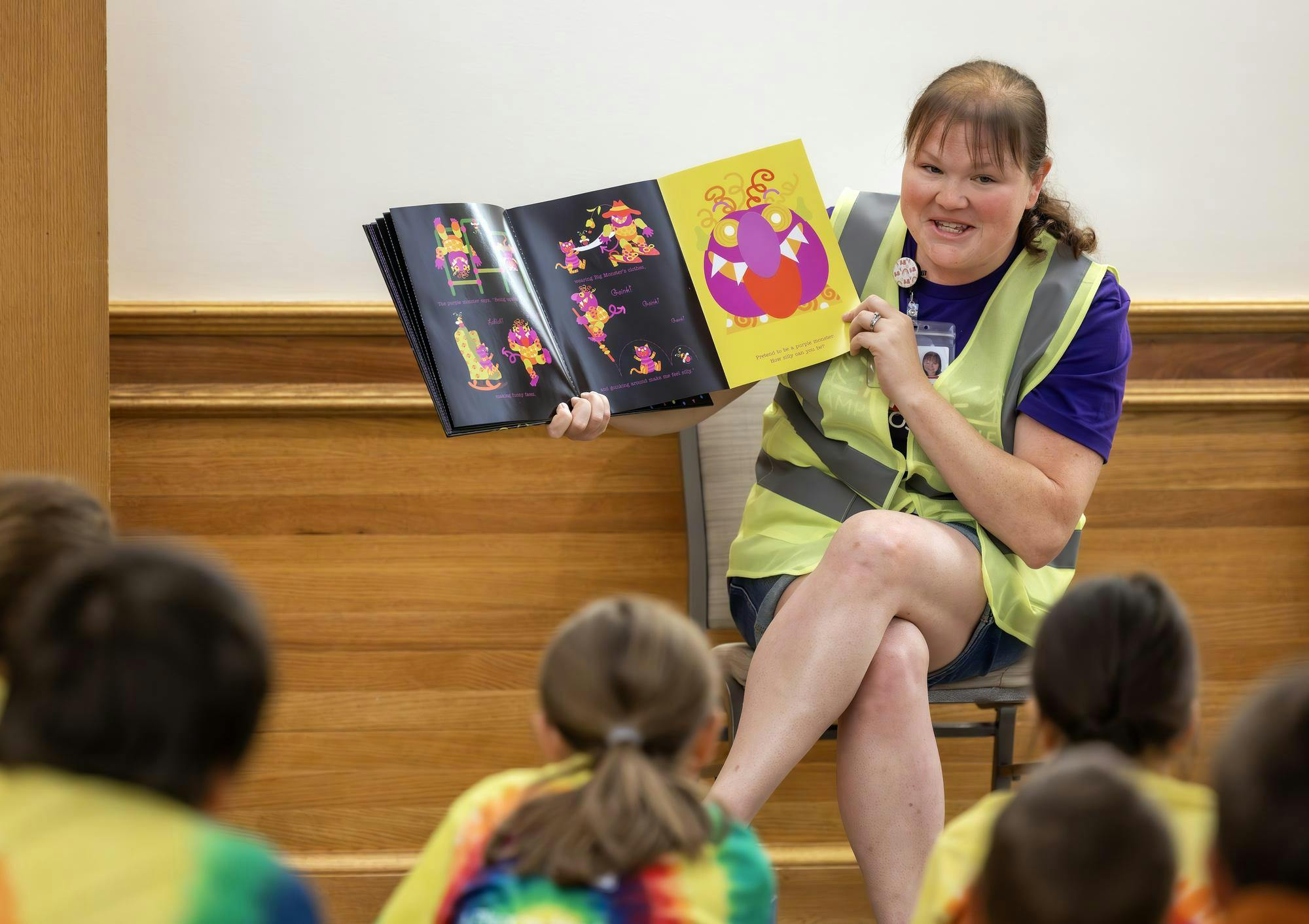 A person reading a book to children. Photo provided by Courtney Schmoll