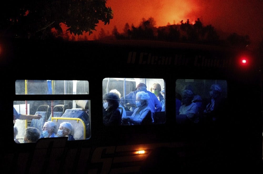 Residents of the Oakmont Gardens senior home evacuate on a bus as the Shady Fire approaches in Santa Rosa Calif., Monday, Sept. 28, 2020. (AP Photo/Noah Berger)