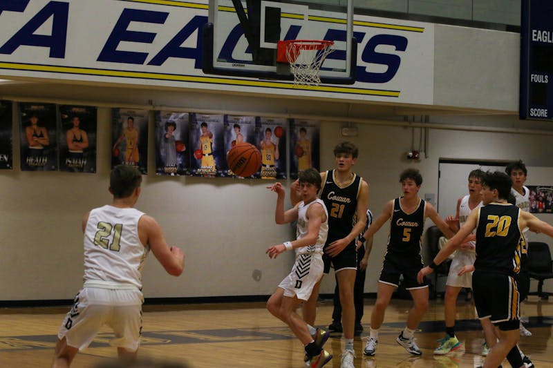 
Daleville Senior Dylan Romine passes the ball to Senior Carson Buck for a 3-point shot during the first quarterfinals game of the Delaware County tournament Jan. 11 at Delta High School. Zach Carter, DN
