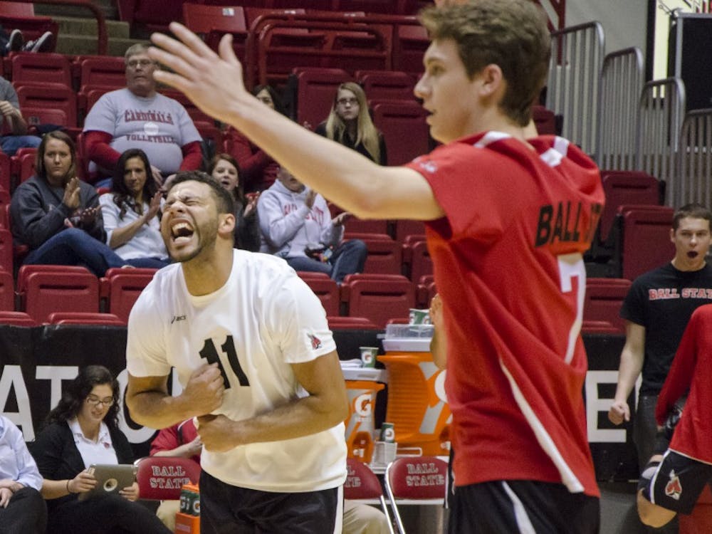Outside attackers Larry Wrather and Shane Witmer celebrate a point for Ball State after a volley with Sacred Heart during the Jan. 11 match in Worthen Arena. DN PHOTO COREY OHLENKAMP