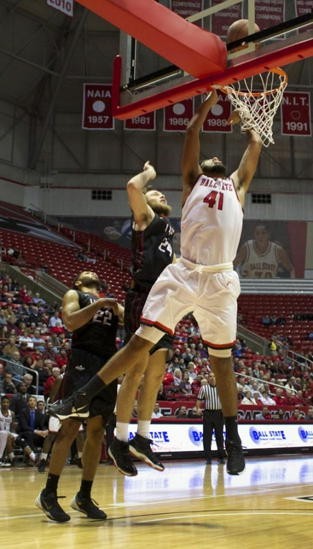 <p>Trey Moses, a freshman forward center for the Ball State Cardinals, attempts to score a layup during the game against IUPUI on Dec. 1 in John E.&nbsp;Worthen Arena. <em>DN PHOTO GRACE RAMEY</em></p>