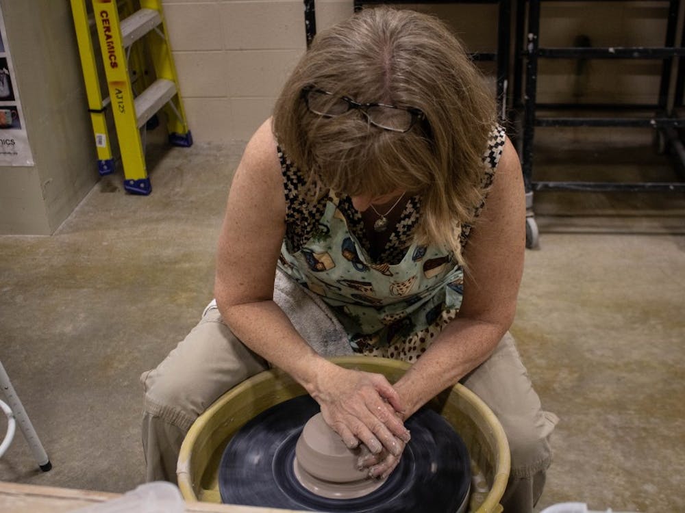 Carol Burt shapes clay into a bowl Wednesday, Aug. 22, 2018 in the Arts and Journalism Building room 225. Burt got involved with the program after taking her first throwing class for credit. Tier Morrow, DN