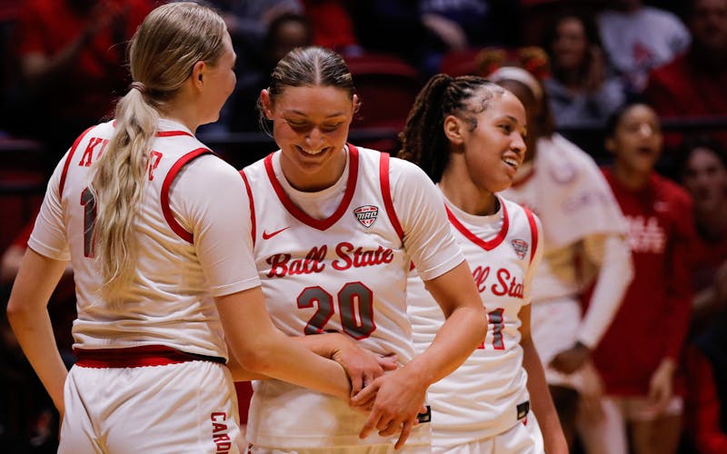 Ball State women's basketball teammates smile after scoring a point against Western Michigan Feb. 1 at Worthen Arena. Ball State defeated the Broncos 61-51. Andrew Berger, DN 