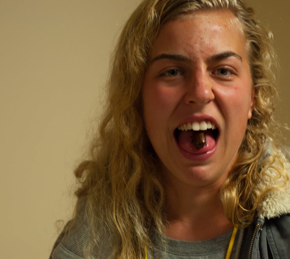 Kitty Taylor shows the insect that she is about to eat on Nov. 5 at The Amazing Taste. DN PHOTO JASON CONERLY