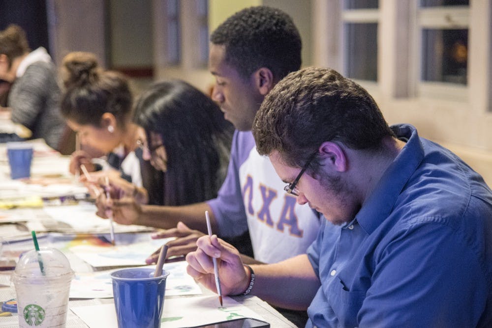 Ball State students water paint oriental pictures as part of an event held by the Asian American Student Association. The water painting event was the first part of their month of events. DN PHOTO RACHEL BRAMMER