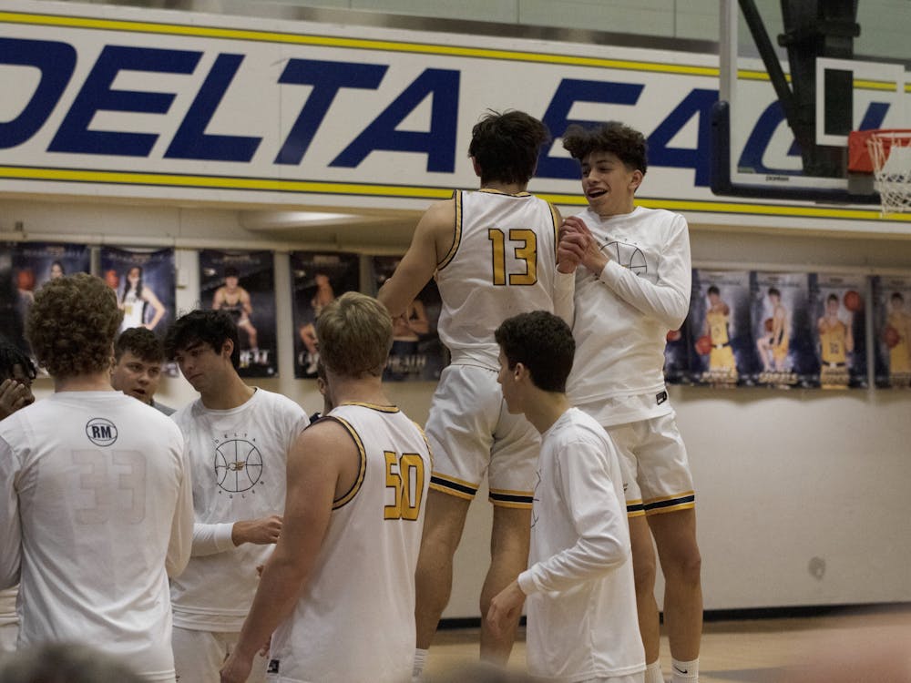 Delta senior Blake Jones chest bumps a teammate during intros of the second quarterfinals game of the Delaware County tournament Jan. 11 at Delta High School in Muncie, Ind. Zach Carter DN