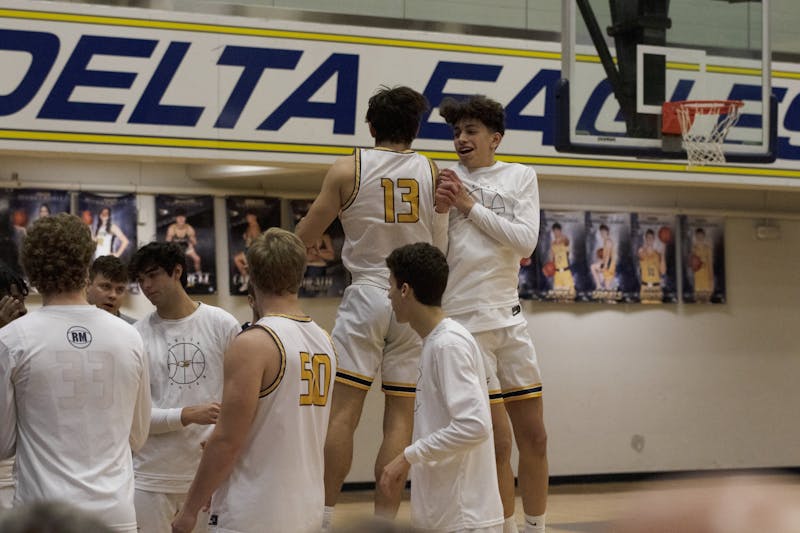 Delta senior Blake Jones chest bumps a teammate during intros of the second quarterfinals game of the Delaware County tournament Jan. 11 at Delta High School in Muncie, Ind. Zach Carter DN