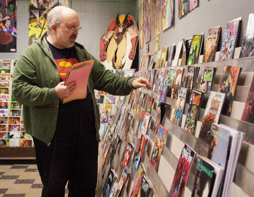 Trent Reeder, owner of Bob’s Comic Castle prepares for the day by putting out new comics Jan. 16, 2019, in Muncie, Indiana. Reeder originally opened Bob’s Comic Castle with his former business partner, Bob Ford. Jack Hart, DN