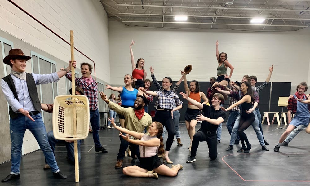 The cast of "Crazy For You" end a dance number in their final rehearsal on March 12 in the Korsgaard Dance Studio. Because props were not completed, the actors gesture toward a laundry basket representing a string bass. Sarah Jenkins, Photo Provided