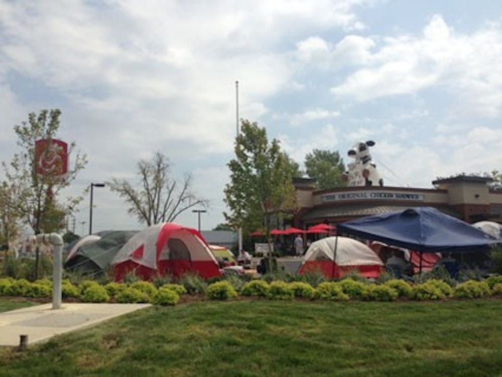 Tents cover the Chick-fil-A parking lot as people wait for the grand opening of the location on McGalliard Avenue. The first 100 people to camp out for a full 24 hours were entered in a raffle to win 52 chicken sandwich coupons, good for the next year.