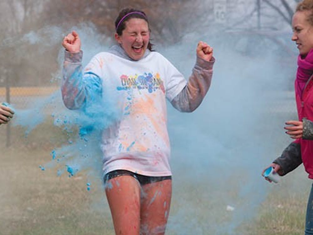 A participant in the Chase the Rainbow 5K emerge from clouds of neon paint during the race. Multiple stations throughout the course were set up and volunteers tossed color powder at runners as they went by. The 350 participants at the run on Saturday raised money for a Muscular Dystrophy Association summer camp. DN PHOTO TAYLOR IRBY