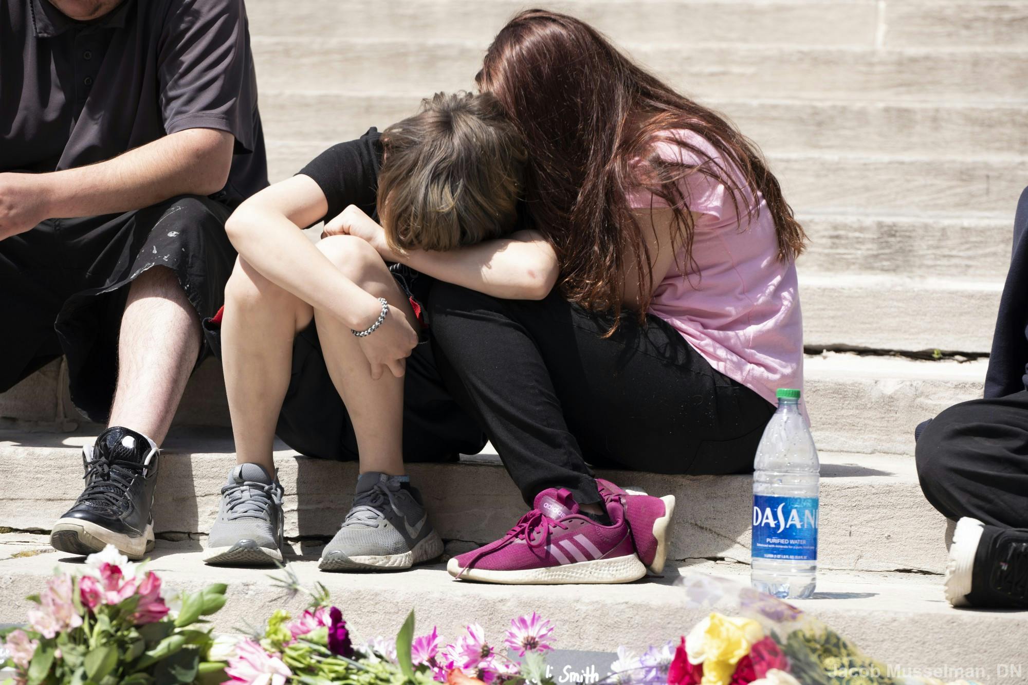 Two family members of one of the victims console one another April 18, 2021, at Monument Circle in Indianapolis. The vigil was held for the eight victims killed in the mass shooting at the FedEx hub in Indianapolis on April 15. Jacob Musselman, DN