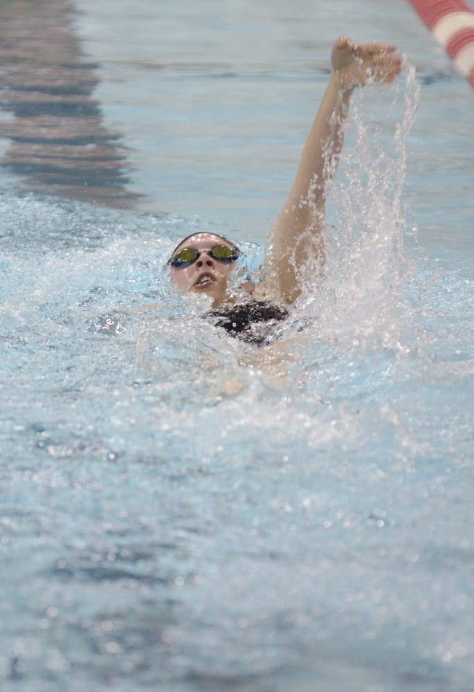 Sophomore Larah Beaver swims the backstroke in the 200-yard in the individual medley race during the 10th annual Doug Coers Invitational on Nov. 22 at Lewellen Aquatic Center. DN PHOTO BREANNA DAUGHERTY 