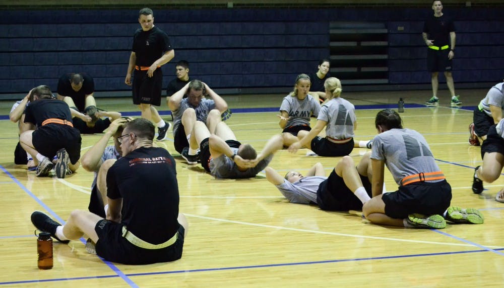<p>Students work on pushups and situps as part of their weekly sessions and monthly physical fitness test. The test consists of the two workouts as well as running miles, and scores a minimum of 180.</p>