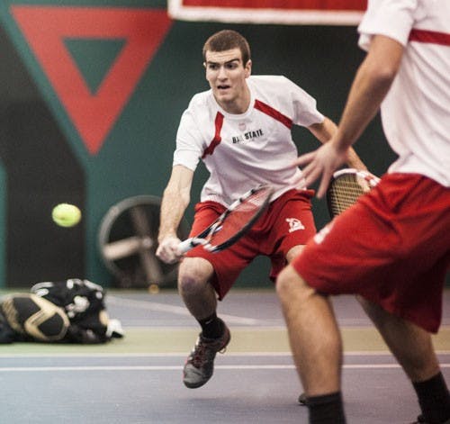 Sophomore Patrick Elliott attempts to return the Dayton volley during the doubles portion of the match. DN PHOTO JONATHAN MIKSANEK