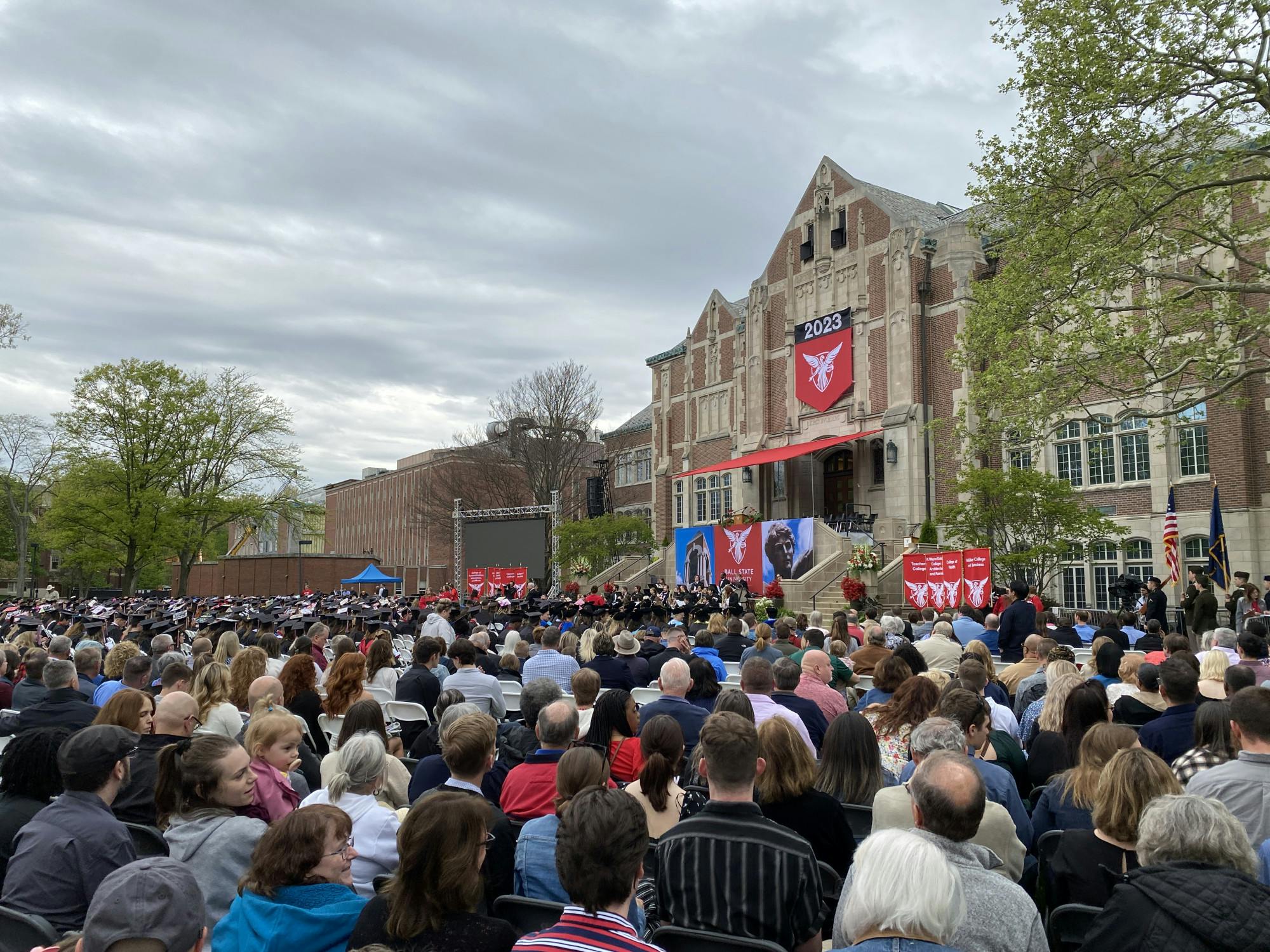 People sit down in the Quad waiting for the main 2023 spring commencement ceremony to begin May 6, 2023. Grayson Joslin, DN