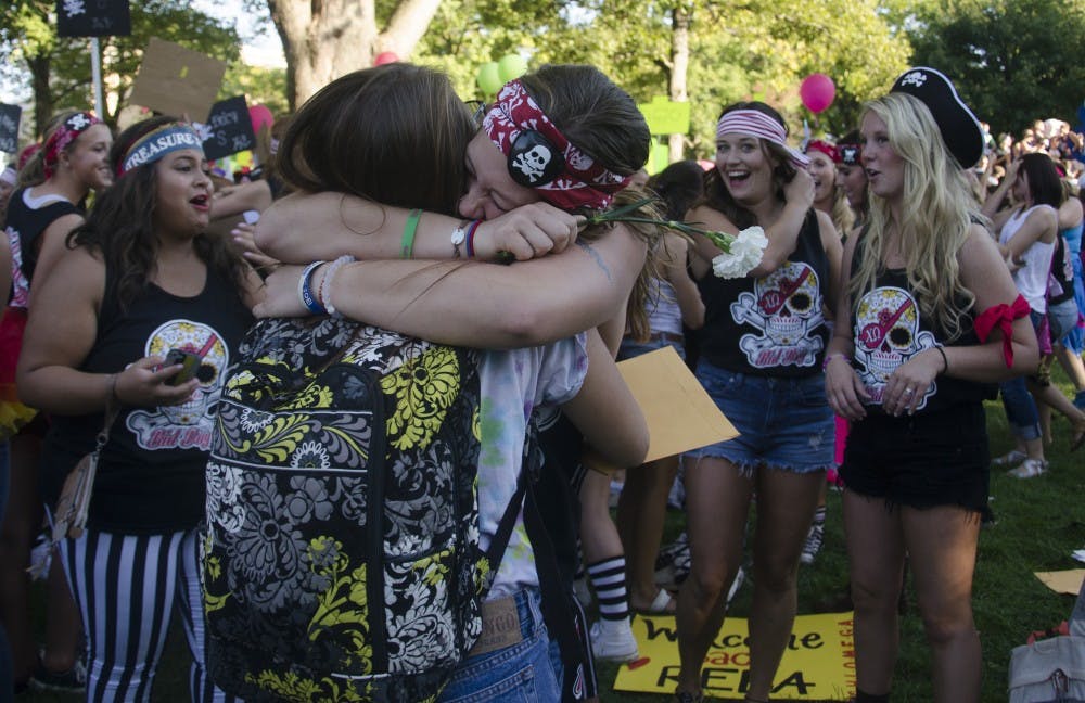 A member of Chi Omega hugs a new member at Bid Day  on Sept. 8 at the Quad. DN PHOTO BREANNA DAUGHERTY 